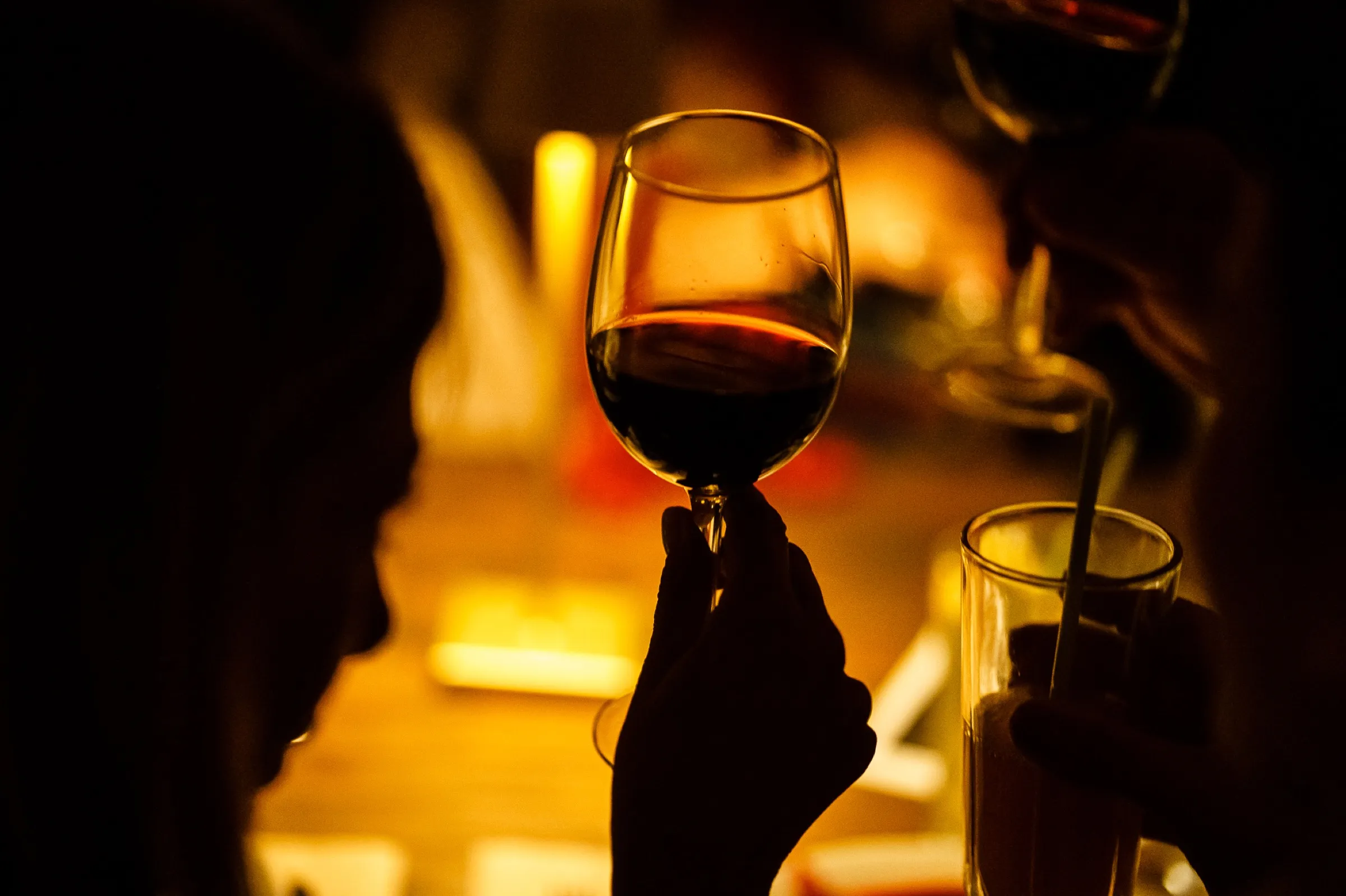 Wine glass in a warm candlelit setting
