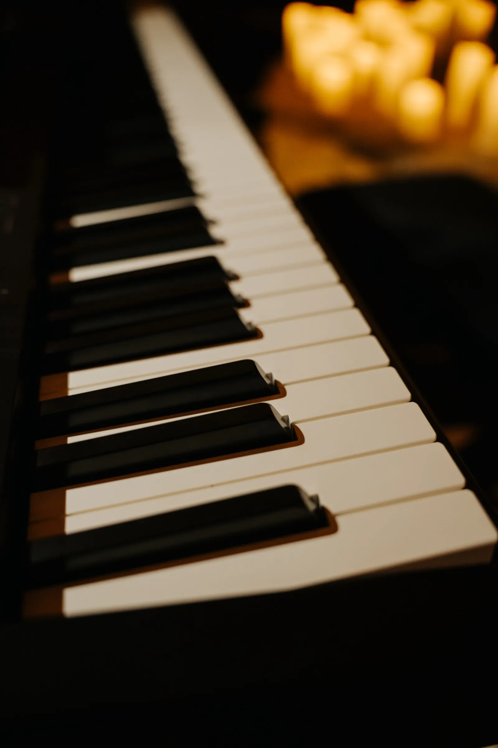 Close view of piano keys in warm light