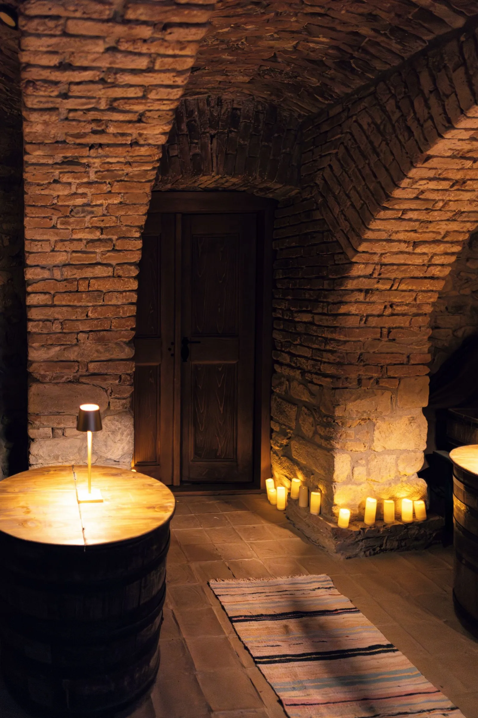 Candlelit brick passage at Kálnoky Castle