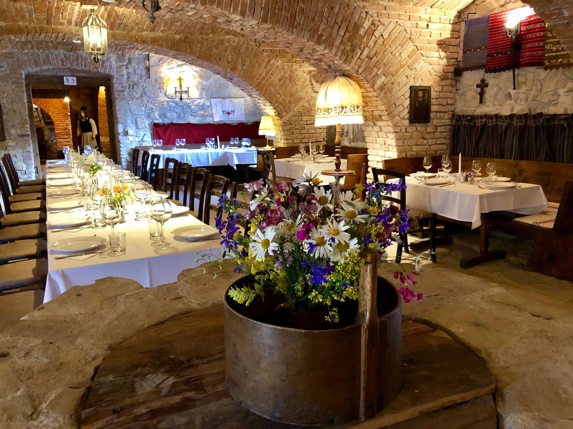 Tables beneath the vaulted stone cellar ceiling