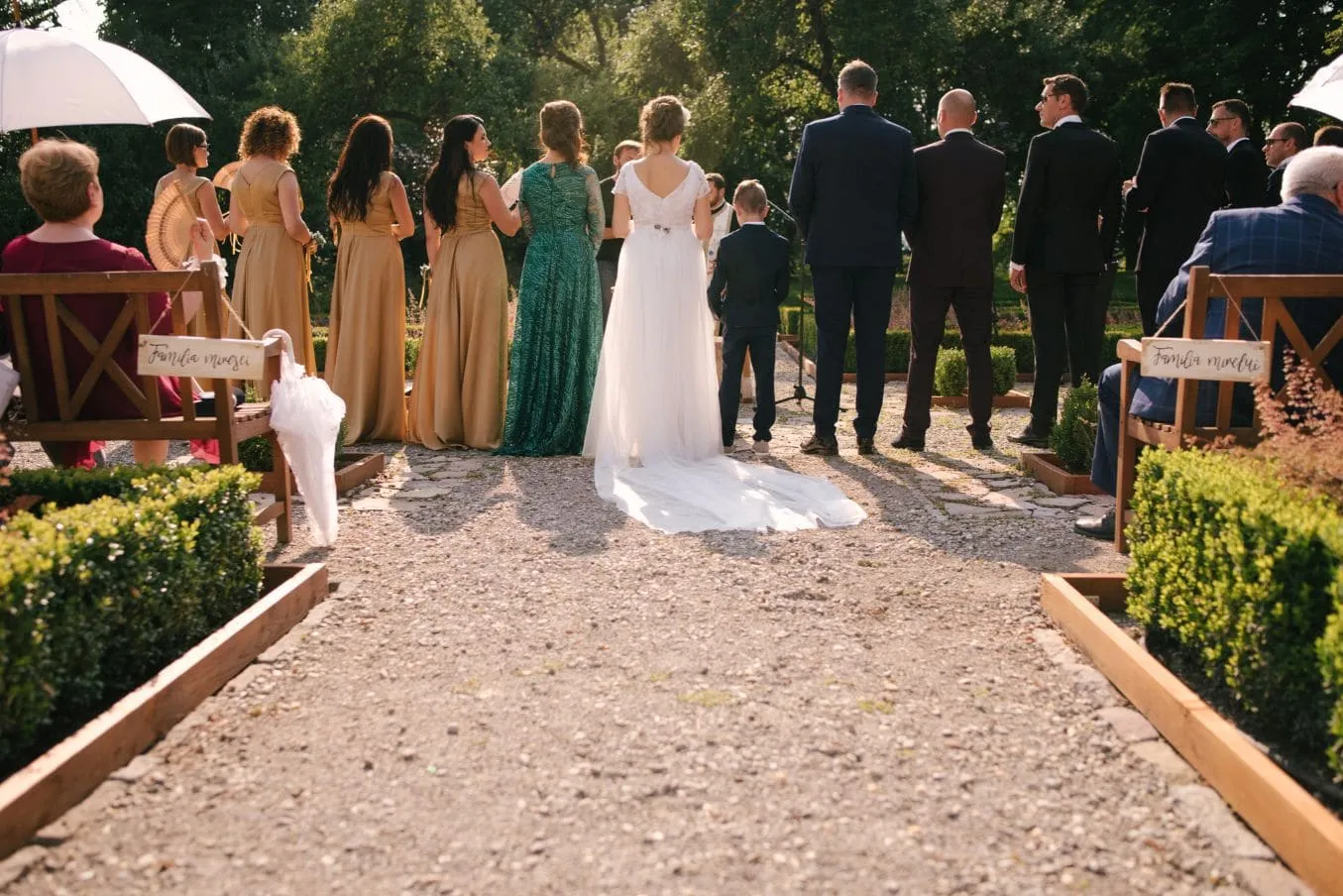 The couple and wedding party during an outdoor ceremony at Miklósvár