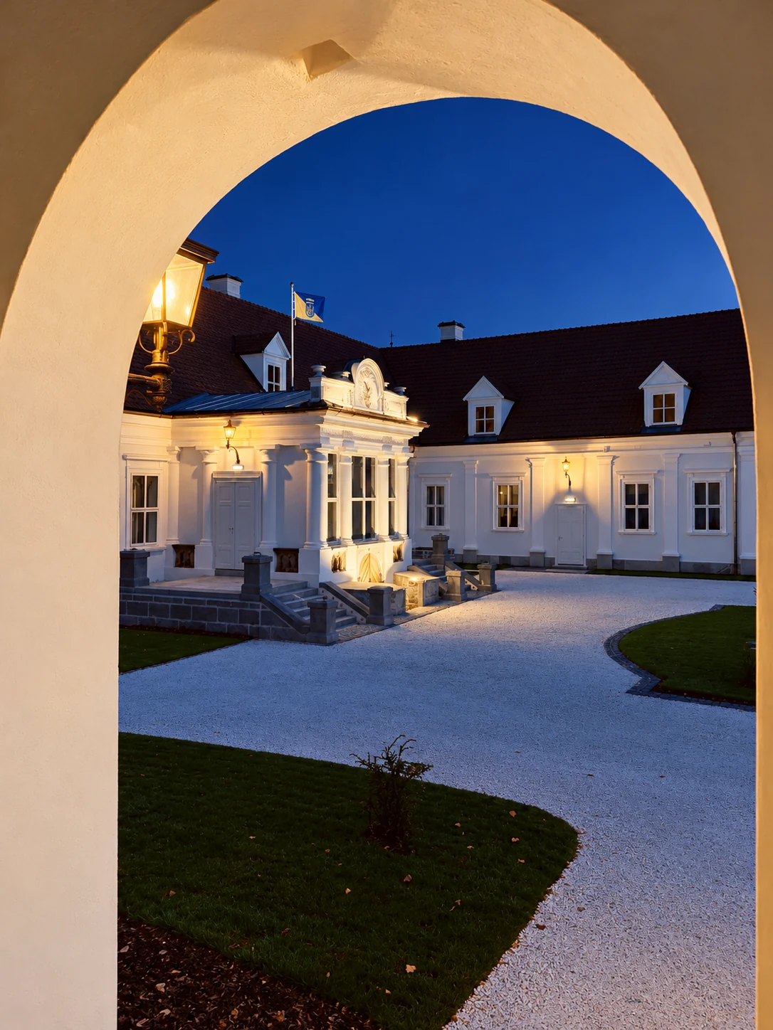 An archway opening onto the castle courtyard at dusk