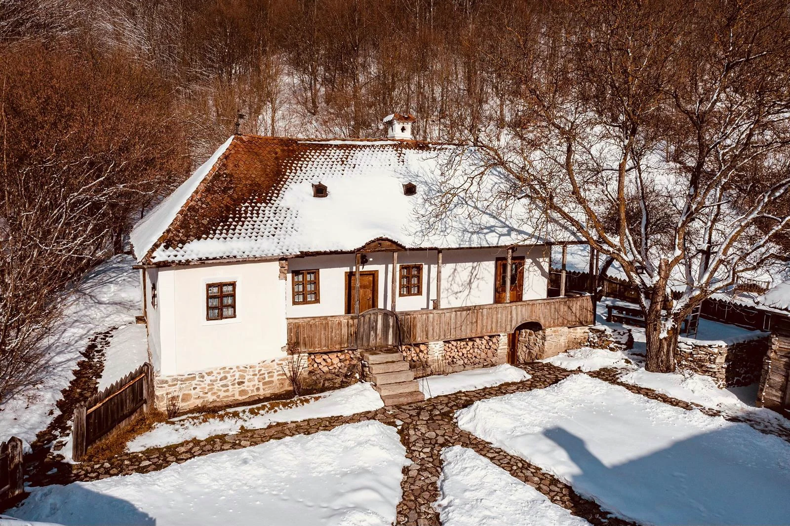 The historic house at Zalánpatak beneath a snow-covered roof