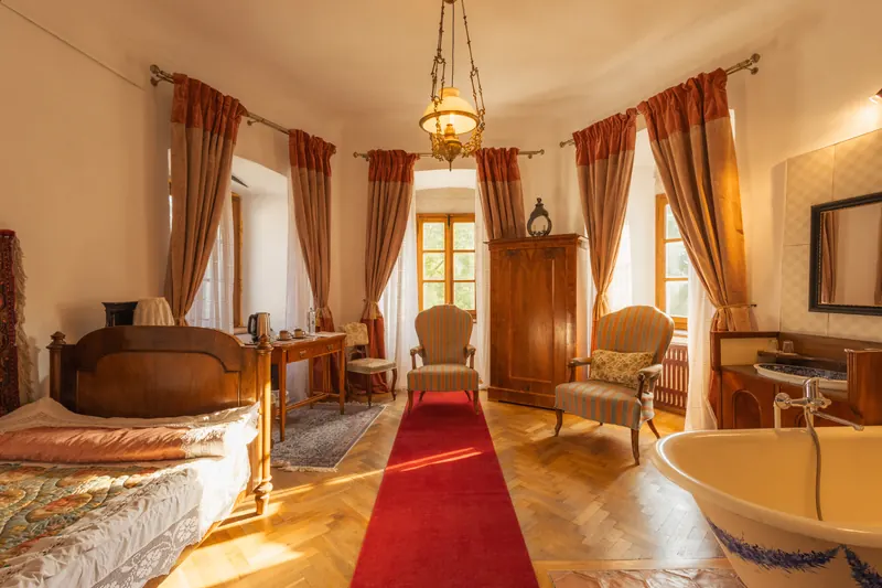 The Princess’s Room inside Miklósvár Castle, with antique beds and a sunlit window