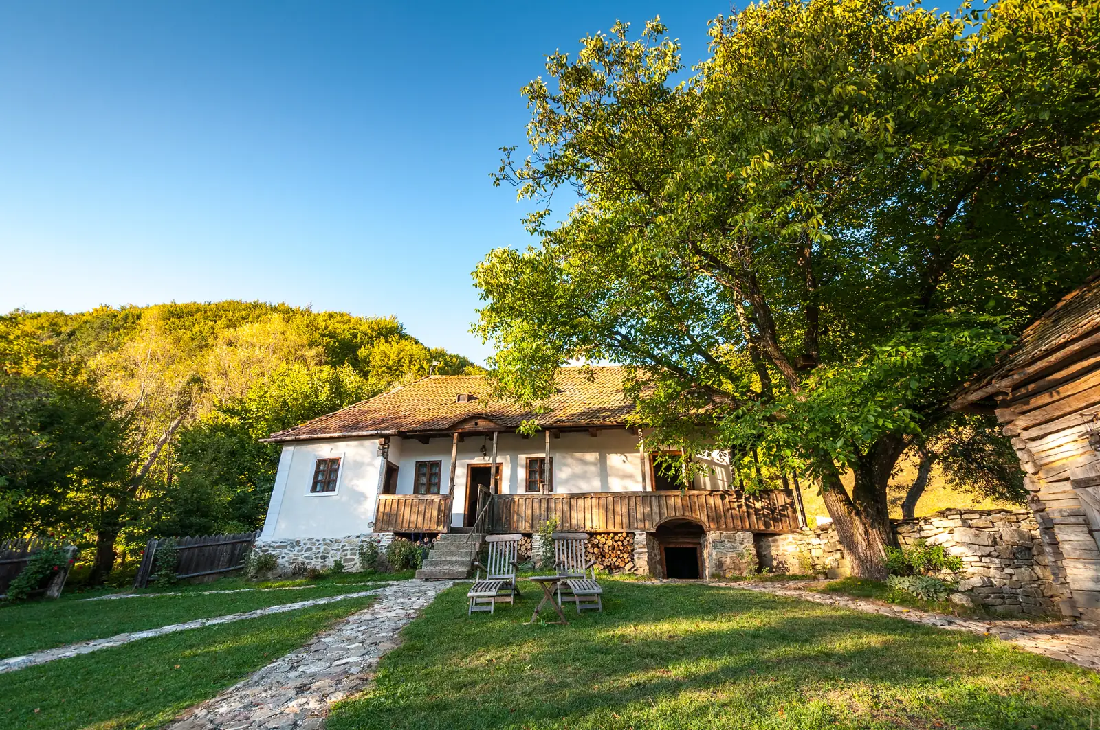Sunlit traditional guesthouse and garden at Zalánpatak
