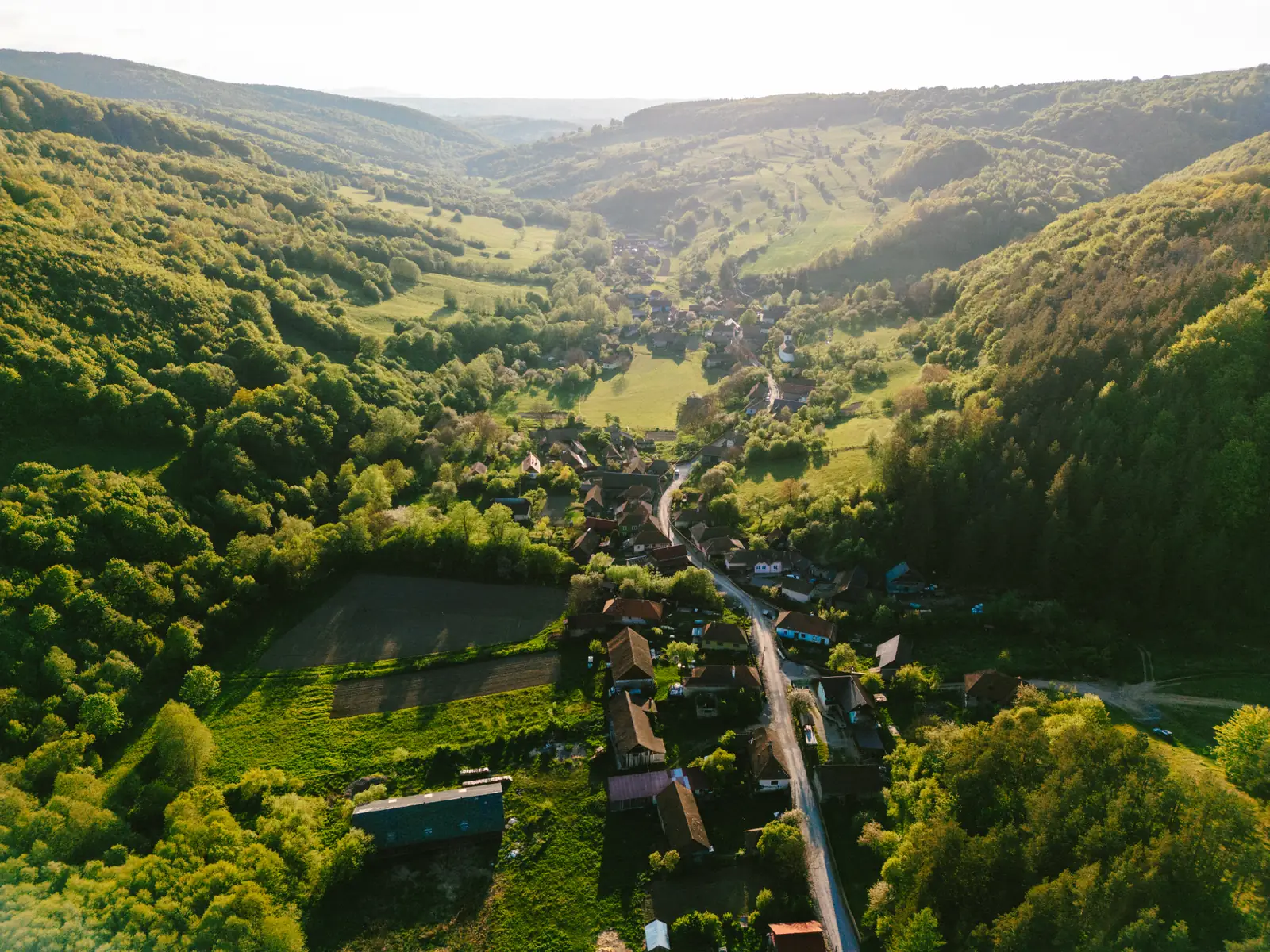 Aerial view of Zalánpatak village among wooded hills and meadows