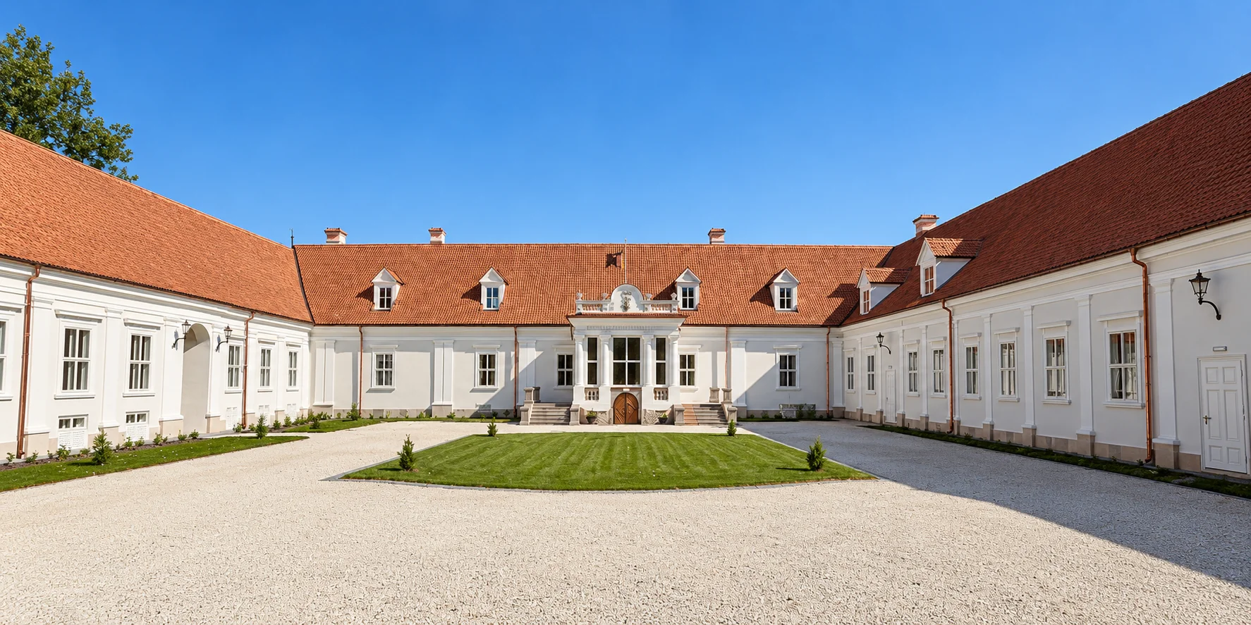 White wings and red roofs around the Kőröspatak castle courtyard